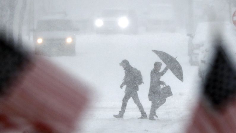 People walk across a snow-covered intersection in Hoboken, New Jersey, on February 9.