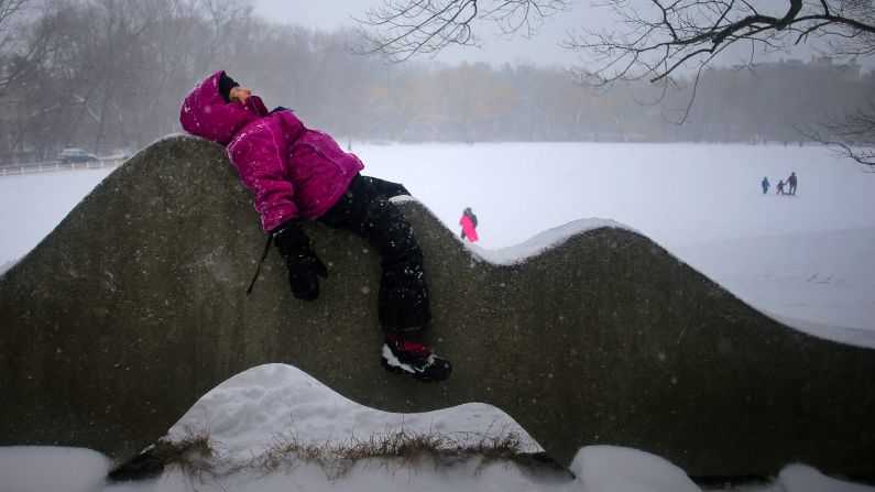 Lina Lennerz rests on a sculpture at a park in Brookline, Massachusetts, on February 9.