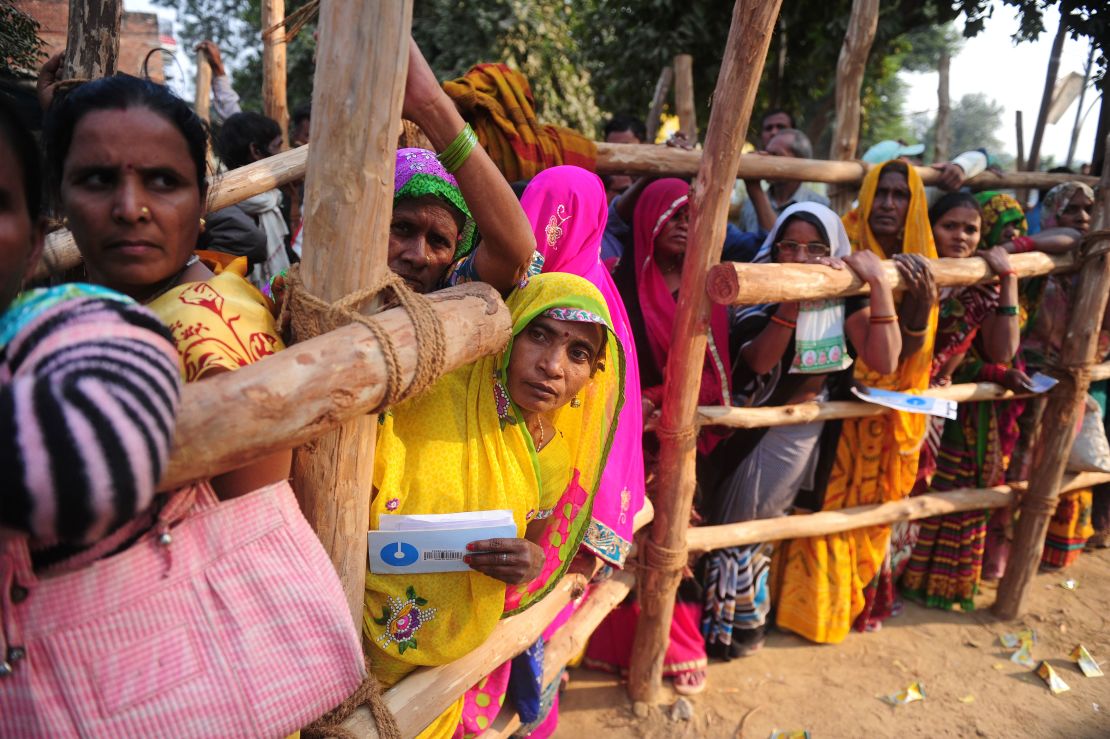 Villagers wait outside a bank to deposit and exchange large rupee notes on the outskirts of Allahabad in Uttar Pradesh. 