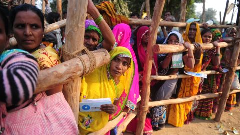 Villagers wait outside a bank to deposit and exchange large rupee notes on the outskirts of Allahabad in Uttar Pradesh.