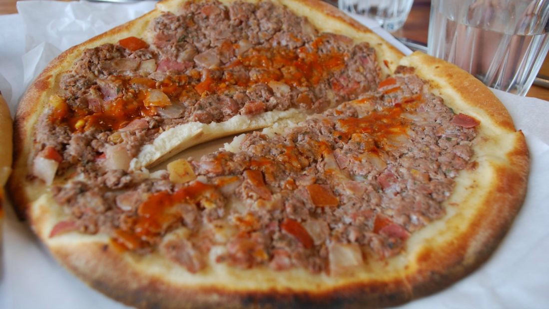 <strong>Manakeesh: </strong>A round bread sprinkled with either cheese, ground meat or herbs (zaatar) which is known as the pizza of the Arabic world.