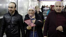 Syrian refugee Baraa Haj Khalaf holds the American flag as she walks with her husband Abdulmajeed and father Khaled Haj Khalaf as she leaves O'Hare International Airport on February 7, 2017 in Chicago, Illinois. 