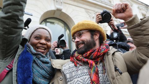 French farmer Cedric Herrou (R) gestures next to a Malian woman named Khadidja as he leaves the Nice court house on February 10, 2017, after his trial for illegally assisting migrants.
