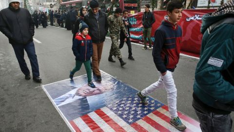 Iranians march on a portrait of Trump in Tehran on Friday.