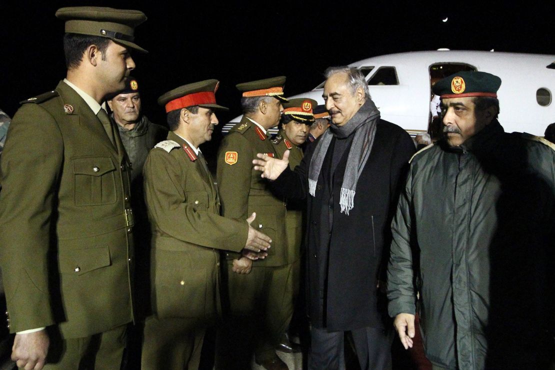 Gen. Haftar, second right,  is greeted upon his arrival at Al-Kharouba airport on December 3, 2016 after a visit to Russia.
