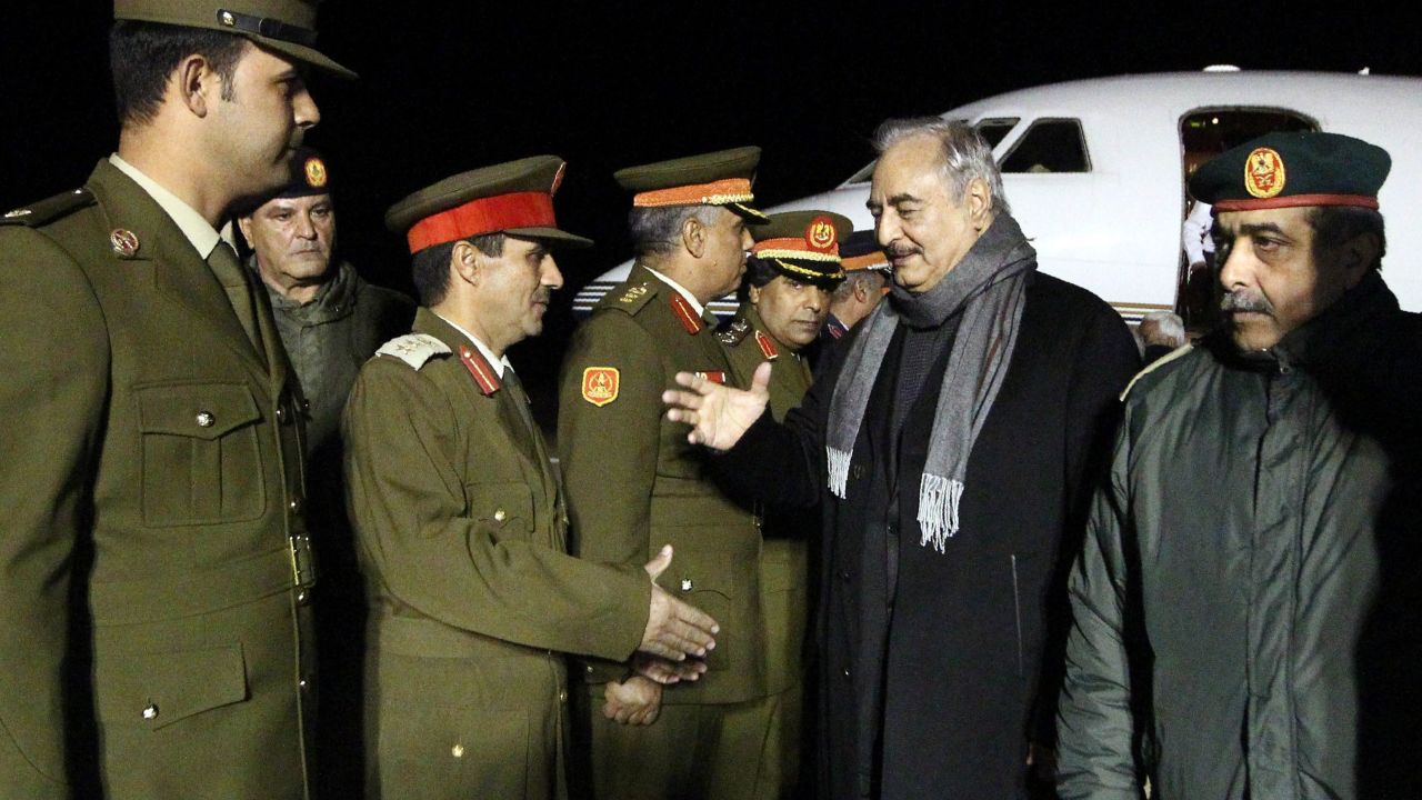 Gen. Haftar, second right, is greeted upon his arrival at Al-Kharouba airport on December 3, 2016 after a visit to Russia.