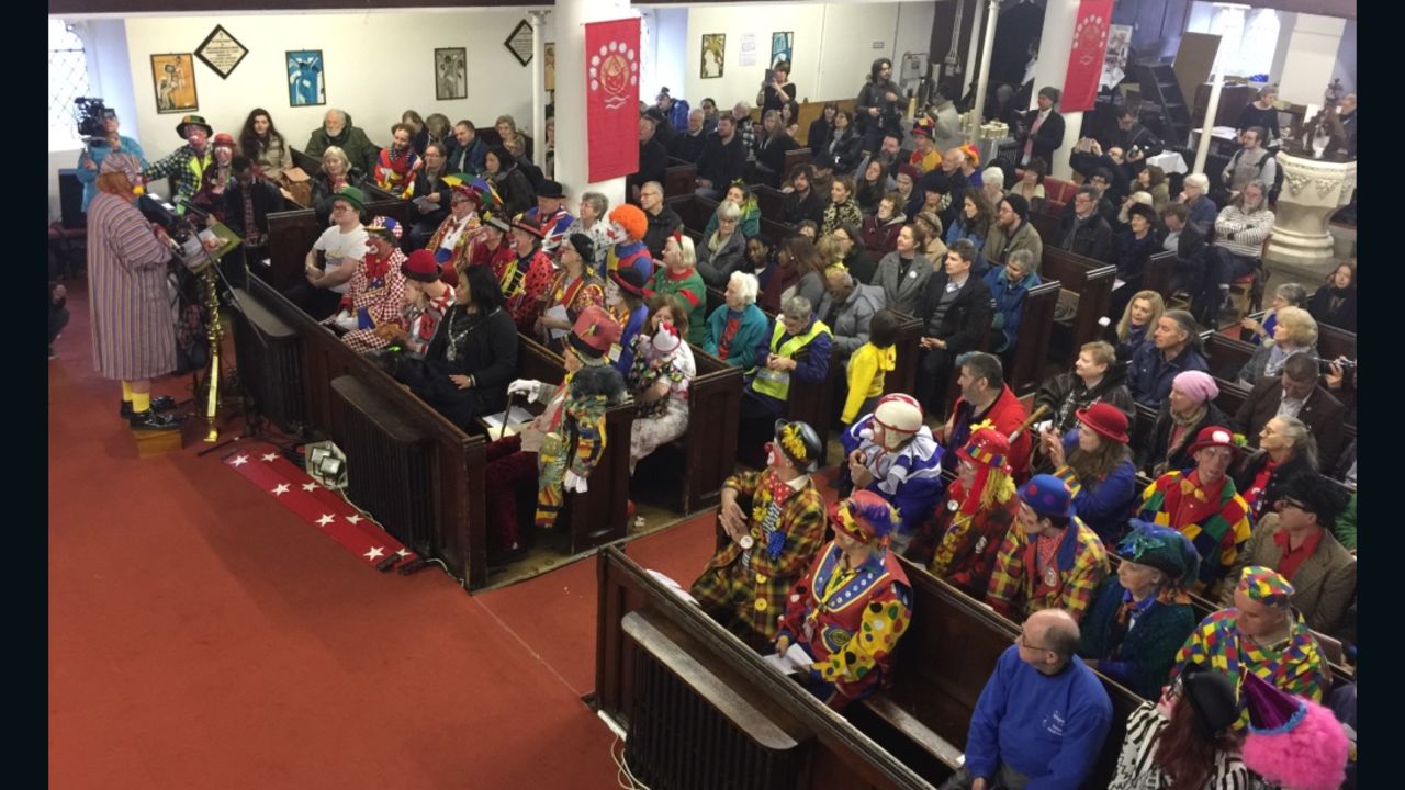 Clowns line the rows of All Saints church in east London. 