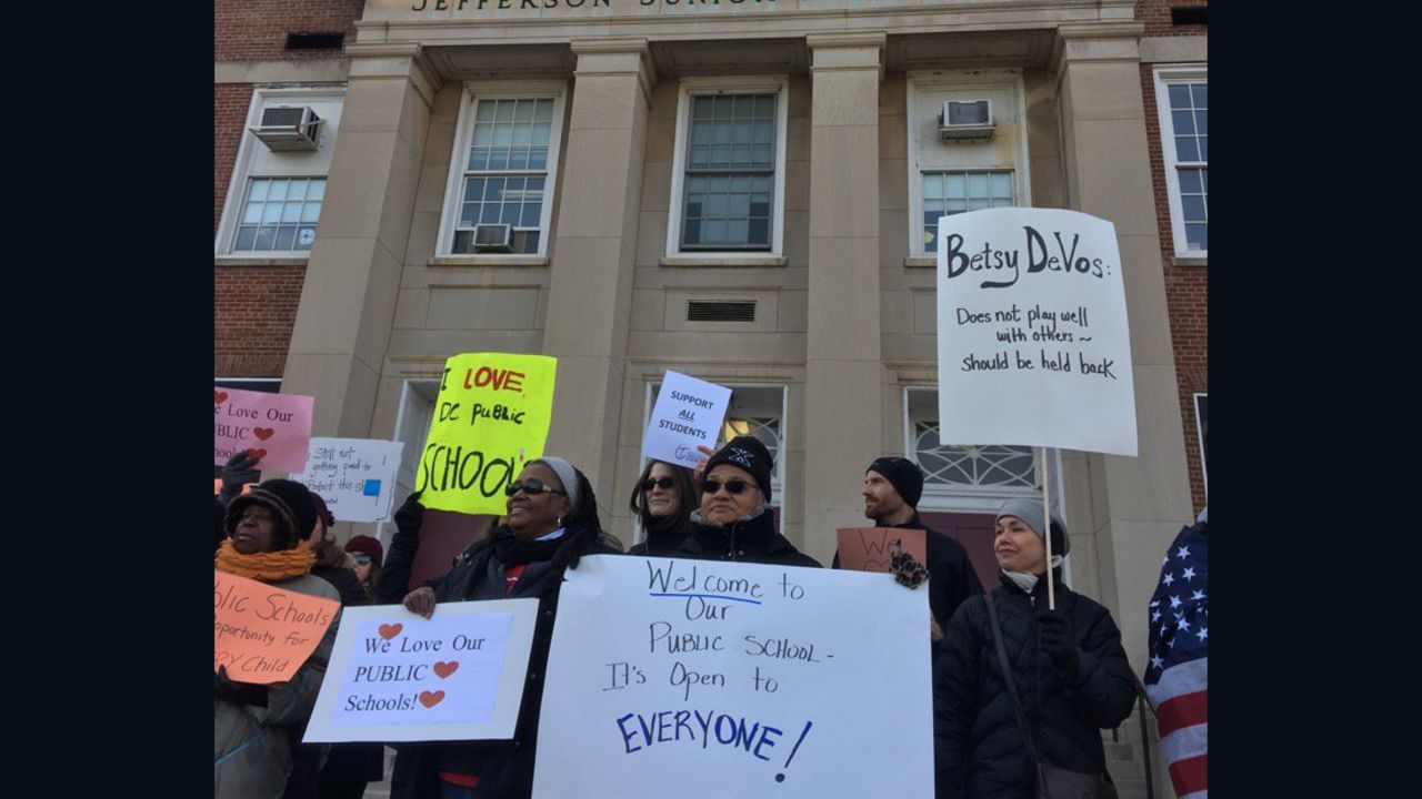 Protesters gather outside Jefferson Middle School Academy in Washington to oppose a visit by Secretary of Education Betsy DeVos.