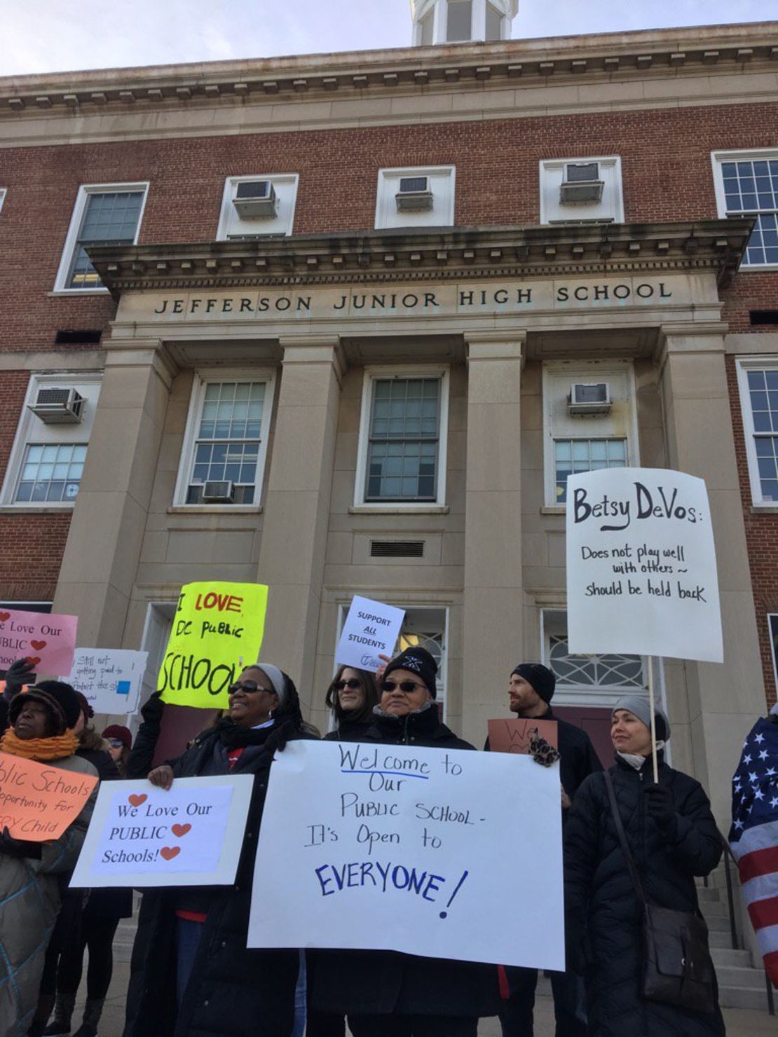 Protesters gather outside Jefferson Middle School Academy in Washington to oppose a visit by Secretary of Education Betsy DeVos.