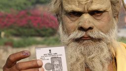 An Indian sadhu - holy man - displays his inked finger and voter card after casting vote in Ayodhya on May 7,2014. More than 95 million voters are eligible to vote in 64 seats in the penultimate leg of the world's biggest general election that ends with results on May 16.  AFP PHOTO        (Photo credit should read STR/AFP/Getty Images)