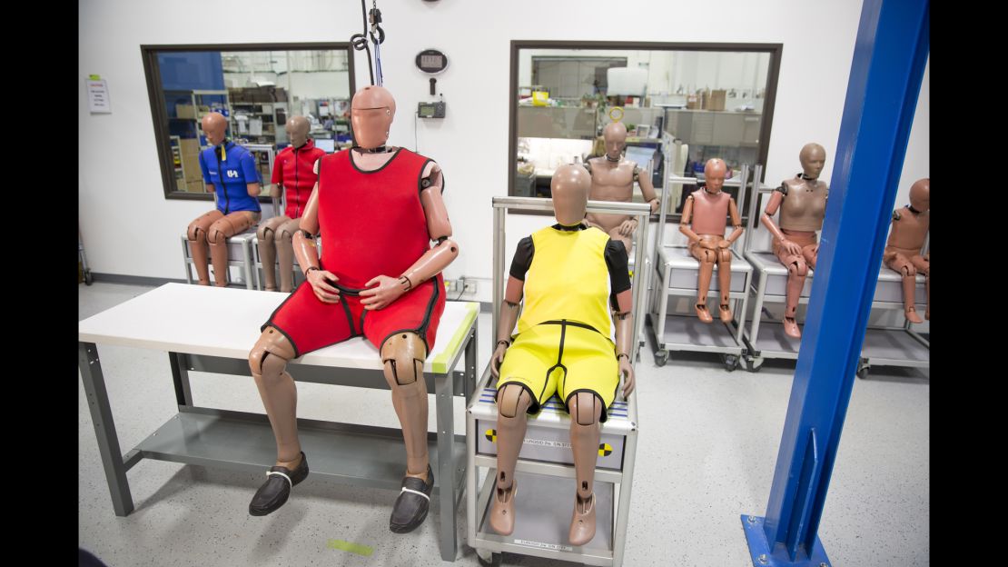 The new obese crash-test dummy (left) sits beside an older, normal-sized dummy.