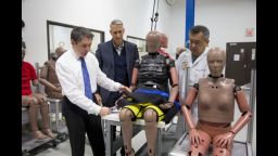 Dr. Stewart Wang demonstrates how to secure an "elderly" crash-test dummy.