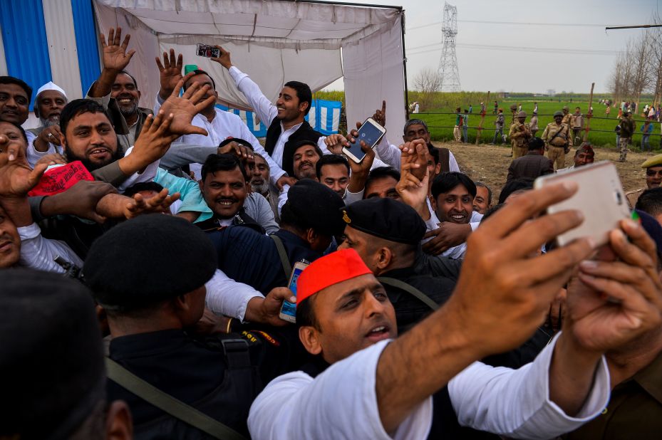 Sitting Chief Minister Akhilesh Yadav of the Samajwadi Party takes a selfie with a phone during a public rally in February 2017.