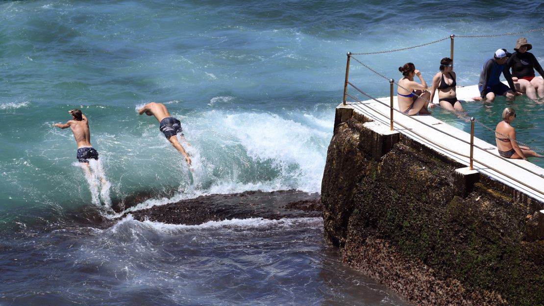 Swimmers jump into the surf at Sydney's Bondi Beach as the city swelters Saturday.