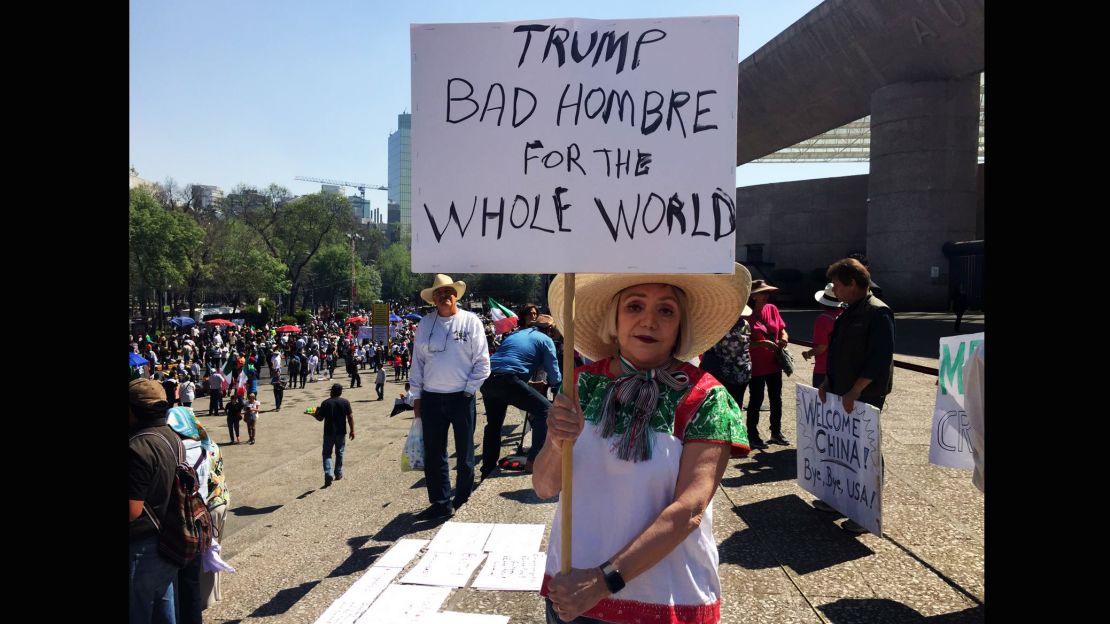 Maria Eugenia Montes de Oca holds up a sign lambasting Trump as a "bad hombre."