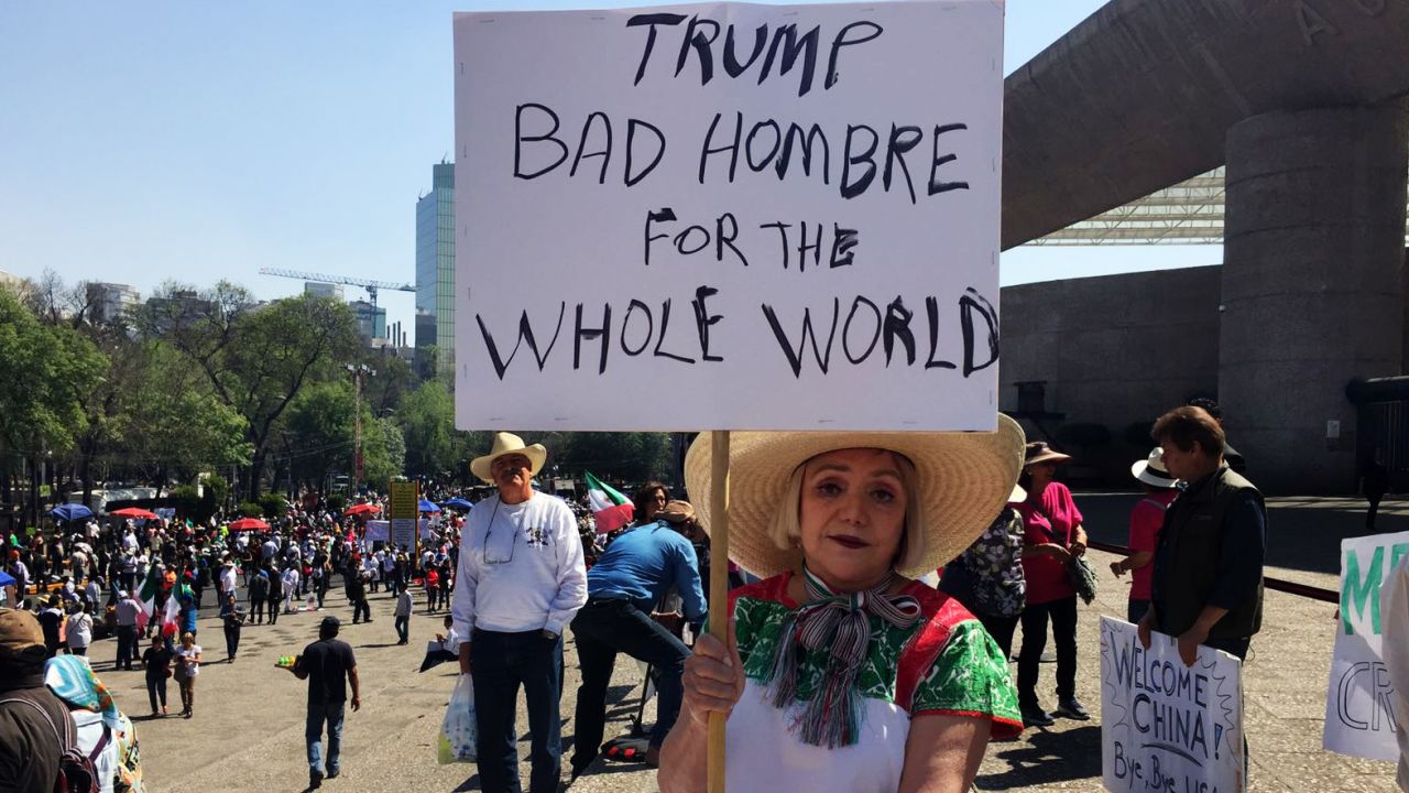 Maria Eugenia Montes de Oca holds up a sign lambasting Trump as a "bad hombre."