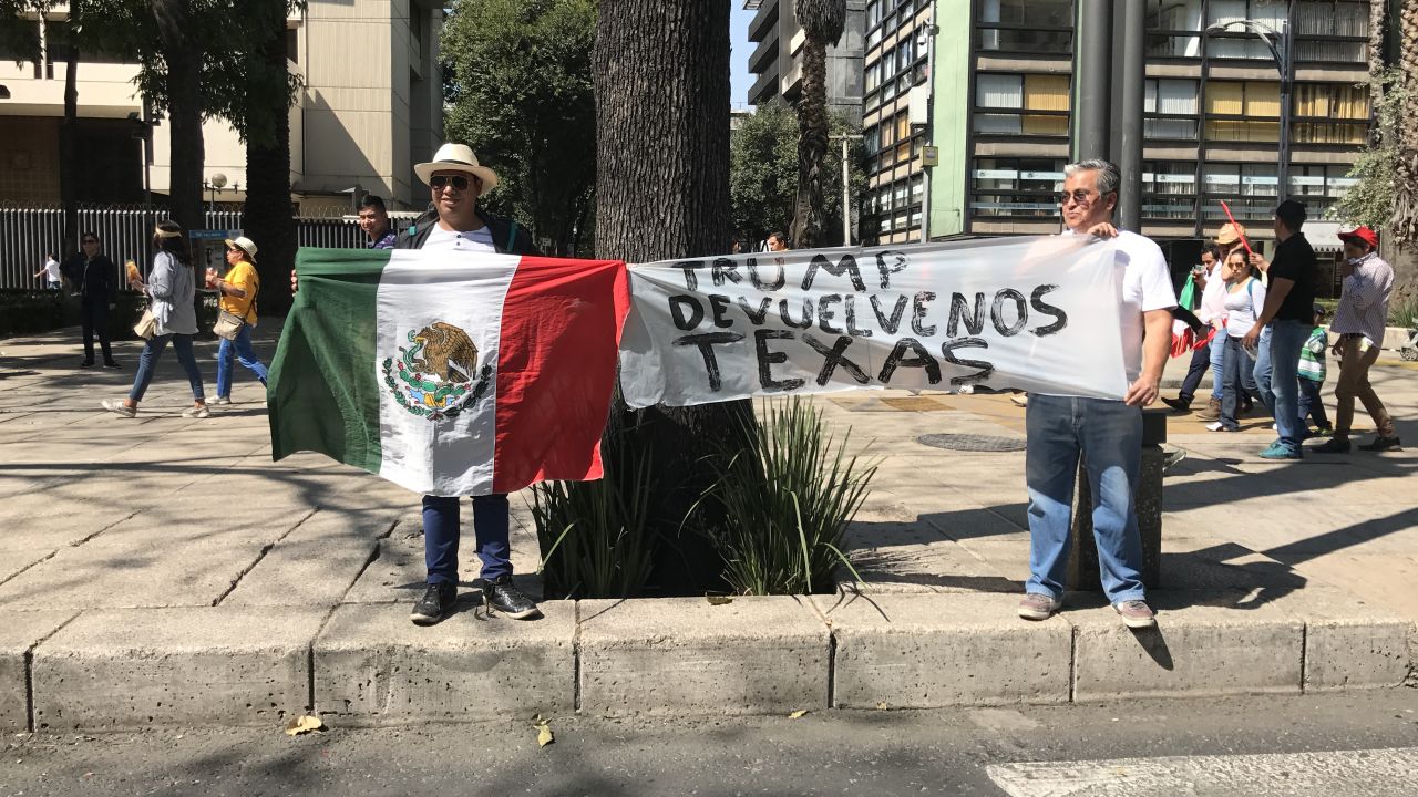 Mexicans took to the streets Sunday to air their grievances against President Donald Trump and to protest corruption in their home country. Two men in Mexico City hold a sign that reads, "Trump, give us Texas back."