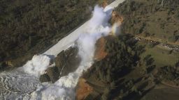 This Saturday, Feb. 11, 2017, aerial photo released by the California Department of Water Resources shows the damaged spillway with eroded hillside in Oroville, Calif. Water will continue to flow over an emergency spillway at the nation's tallest dam for another day or so, officials said Sunday. (William Croyle/California Department of Water Resources via AP)