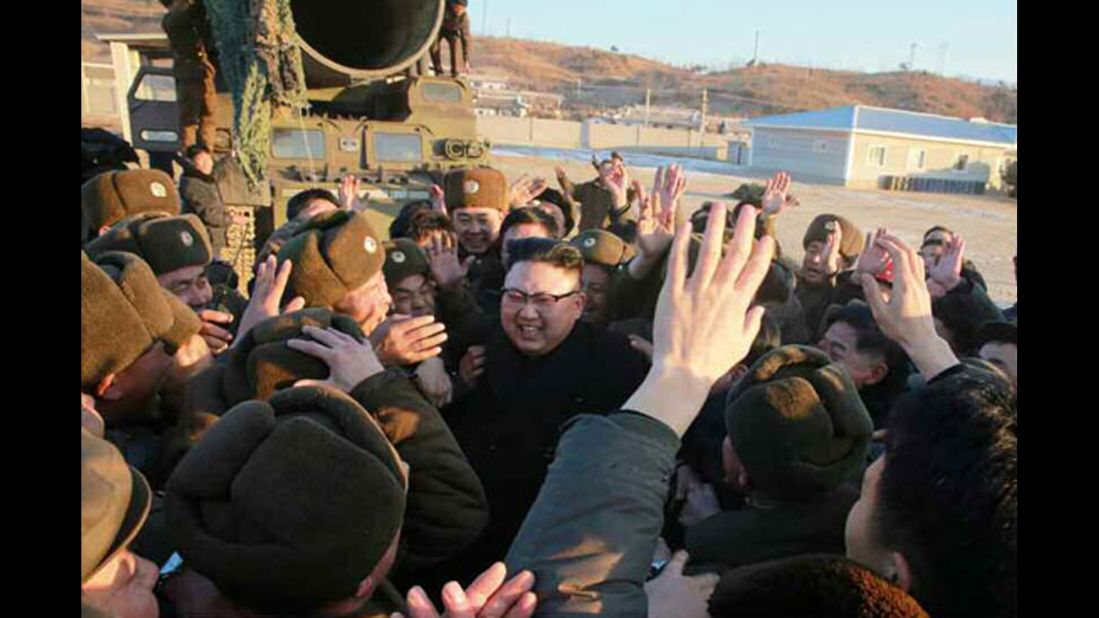 Kim celebrates with soldiers after the missile test, which North Korean state media claimed was successful.