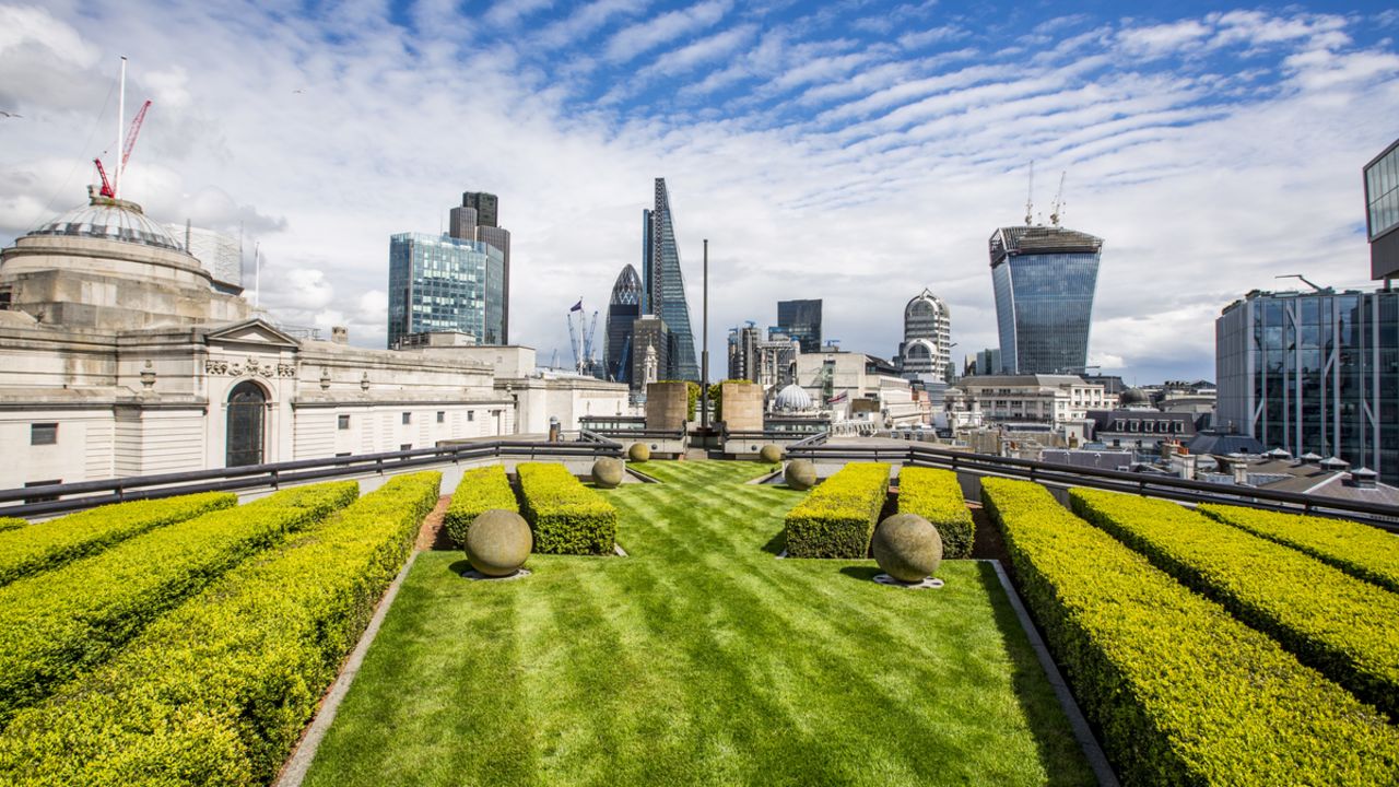 Admire London's eastern cluster of skyscrapers from Coq d'Argent's manicured lawn.