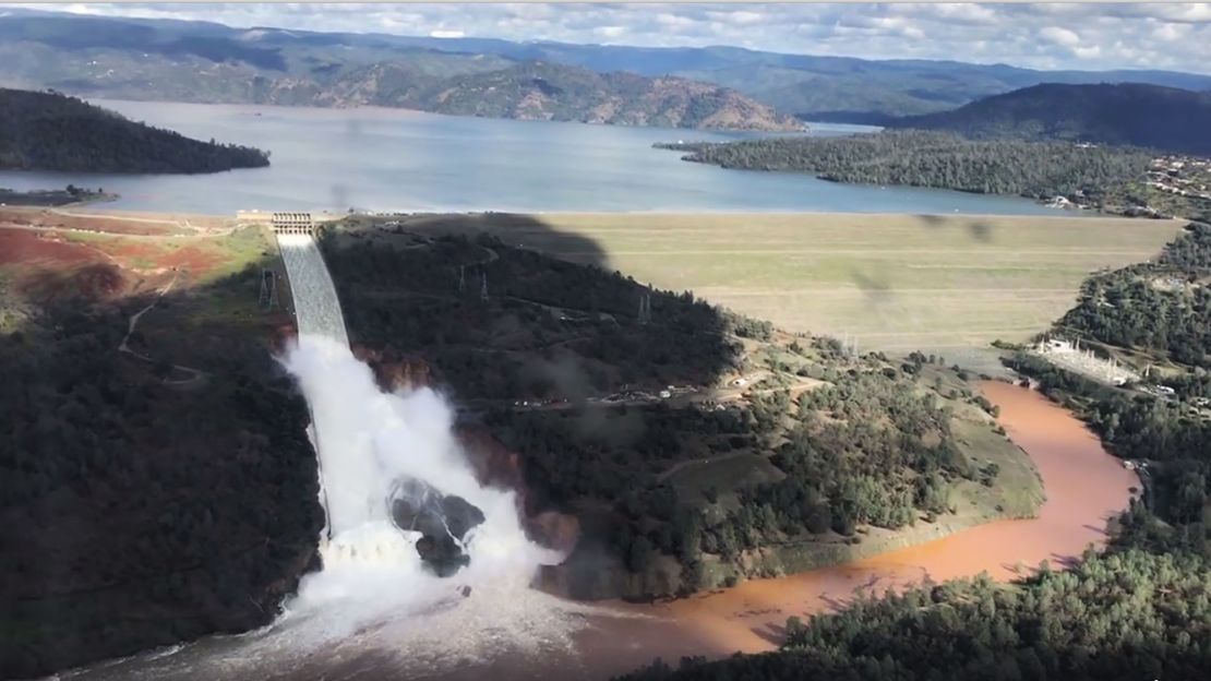 Water flows over an emergency spillway of the Oroville Dam in Oroville, Calif. on Feb. 10