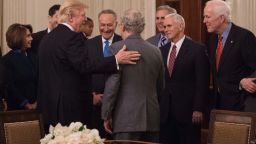 US President Donald Trump speaks with Senate Majority Leader Mitch McConnell (L) as House Minority Leader Nancy Pelosi (L) Senate Minority Leader Chuck Schumer (3rd L) House Majority Leader Kevin McCarthy (3rd R), Vice President Mike Pence (2nd L) and Senate Majority Whip John Cornyn (R) during a reception with Congressional leaders on January 23, 2017 at the White House in Washington, DC. / AFP / NICHOLAS KAMM      