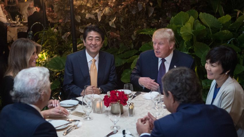 US President Donald Trump, Japanese Prime Minister Shinzo Abe (2nd-L), his wife Akie Abe (R), US First Lady Melania Trump (L) and Robert Kraft (2nd-L),owner of the New England Patriots, sit down for dinner at Trump's Mar-a-Lago resort on February 10, 2017. / AFP / NICHOLAS KAMM  