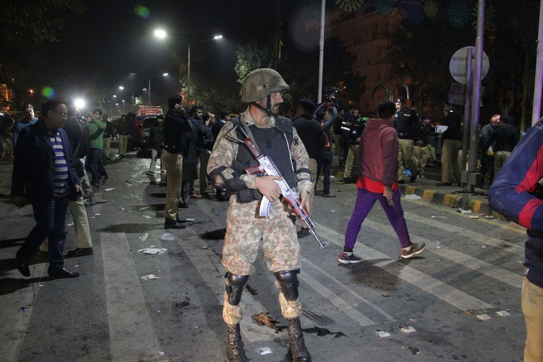 Police and security officers cordon off the area of a deadly bombing, in Lahore, Pakistan, on Monday, February 13, 2017.