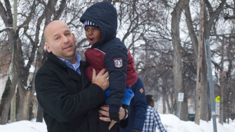 J.P. Venegas, who drives back and forth to the border picking up refugees for Welcome Place, with a child who crossed with his family.