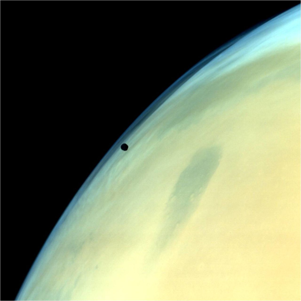 Phobos, one of the two natural satellites of Mars, silhouetted against the Martian surface.