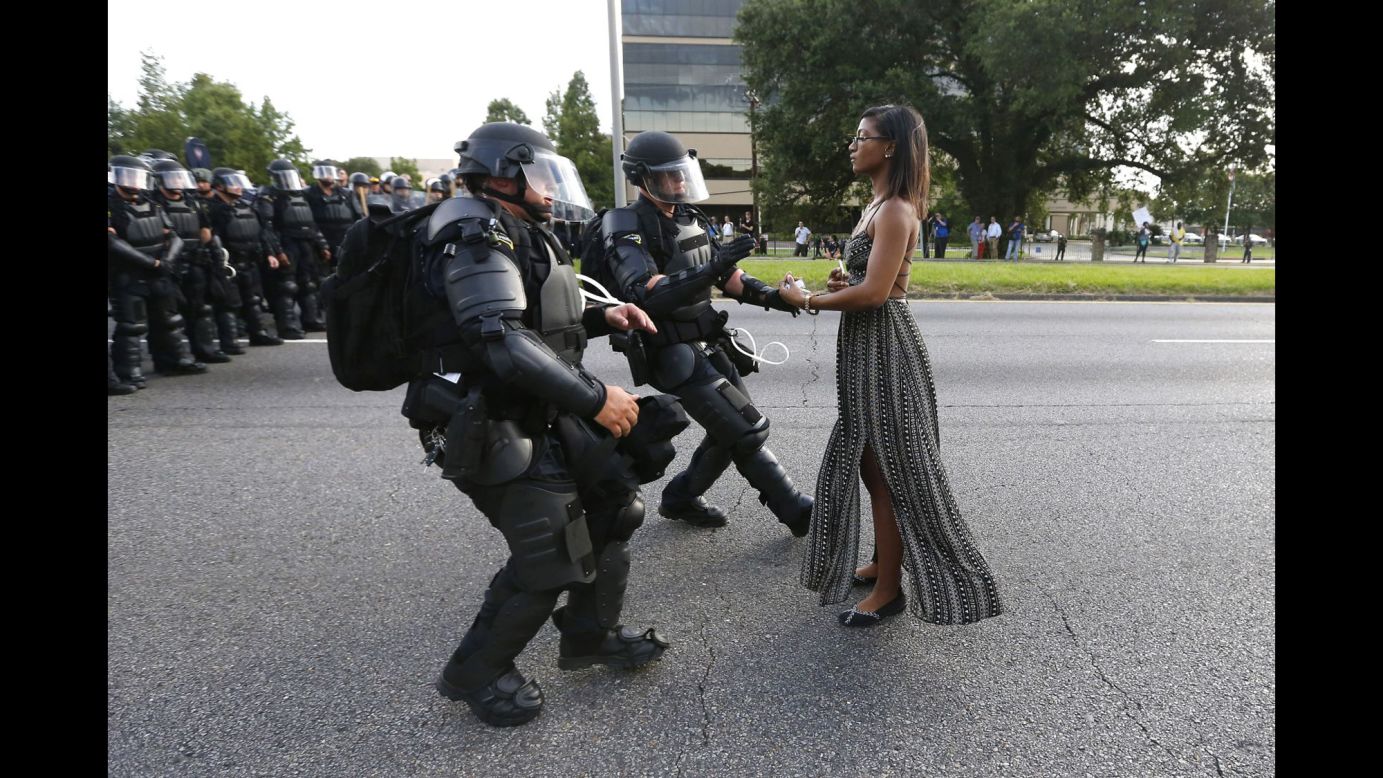 Ieshia Evans stands in the street July 9 as two police officers move in to arrest her near the headquarters of the Baton Rouge Police Department in Louisiana. Evans was one of hundreds of protesters <a href="http://www.cnn.com/2016/07/09/us/black-lives-matter-protests/" target="_blank">who blocked a Baton Rouge roadway</a> to decry police brutality.