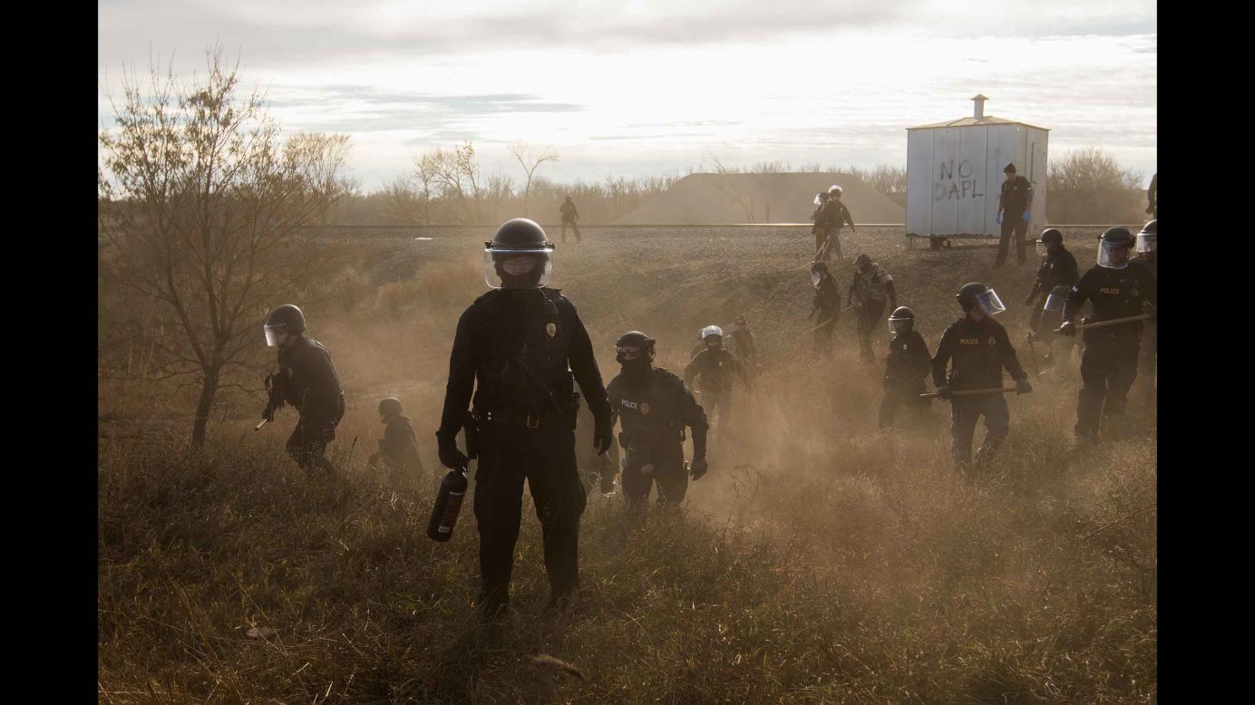 Riot police clear protesters from a secondary road outside a Dakota Access Pipeline worker camp. The <a href="http://www.cnn.com/2016/09/07/us/dakota-access-pipeline-visual-guide/" target="_blank">Dakota Access Pipeline</a> is a $3.7 billion project that would cross four states and change the landscape of the US crude oil supply. But the Standing Rock Sioux tribe says the pipeline would affect its drinking-water supply and destroy its sacred sites.