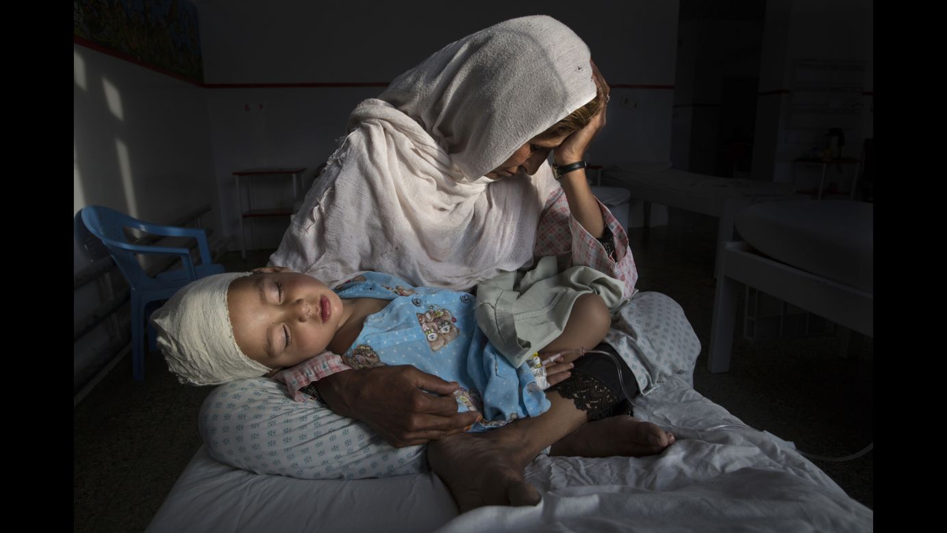 Najiba holds her 2-year-old nephew, Shabir, at a hospital in Kabul, Afghanistan. Shabir was injured in a bomb blast that killed his sister on March 29. Najiba had to stay with the children as their mother buried her daughter.