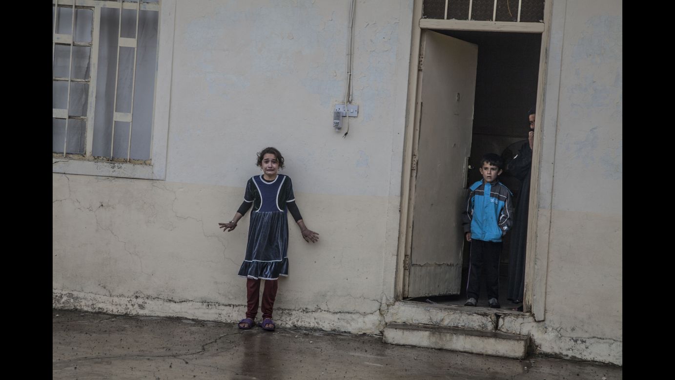 Children are photographed as Iraqi forces search a home in Mosul, Iraq, on November 2. An Iraqi-led coalition is underway to reclaim the largest region of Iraq under ISIS control.