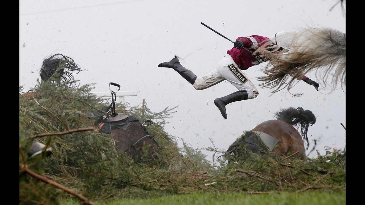 Jockey Nina Carberry flies off her horse, Sir Des Champs, during the Grand National steeplechase in Liverpool, England, on April 9.