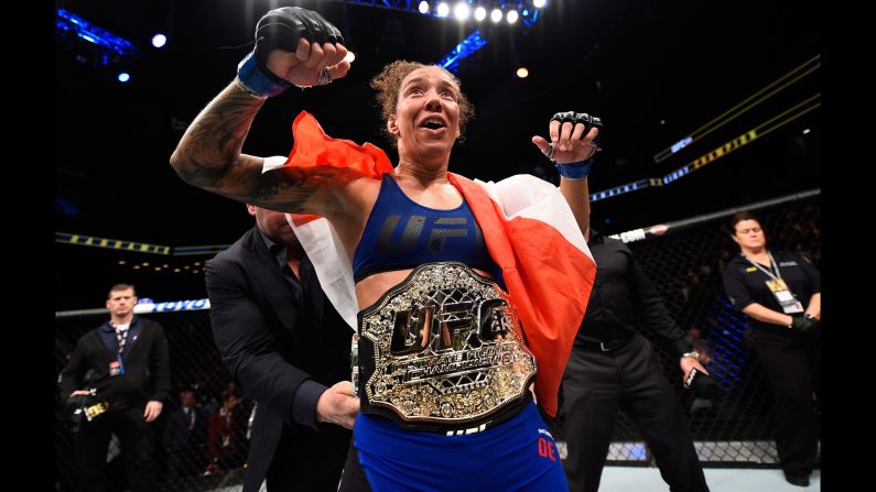 Germaine de Randamie celebrates her victory over Holly Holm in the main event of UFC 208 on Saturday, February 11. De Randamie won by unanimous decision, earning the UFC's inaugural featherweight title.