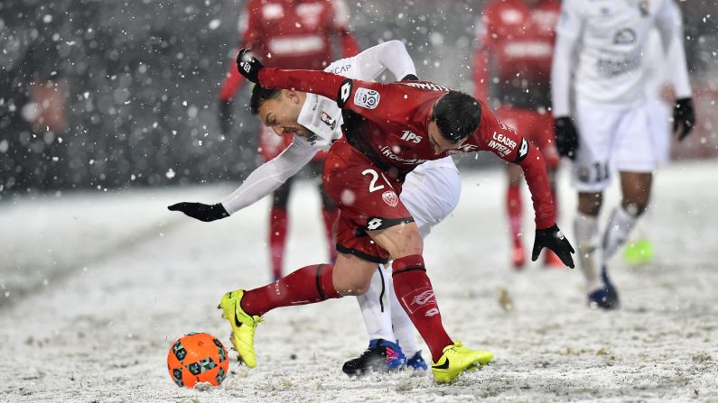 Caen midfielder Steed Malbranque, in white, competes for the ball with Dijon's Romain Amalfitano during a French league match in Dijon on Saturday, February 11.