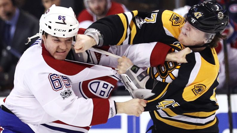 Montreal's Andrew Shaw, left, fights Boston's Torey Krug during an NHL hockey game in Boston on Sunday, February 12.