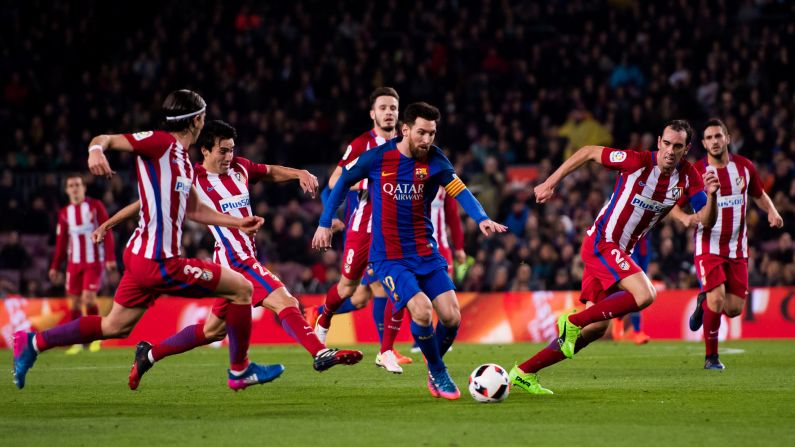 Barcelona star Lionel Messi is swarmed by Atletico Madrid players during a Copa del Rey match in Barcelona, Spain, on Tuesday, February 7. Barcelona advanced to the tournament final with a 3-2 score over two legs.