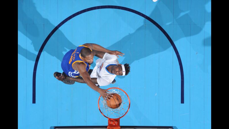 Kevin Durant throws down a dunk against his former team, the Oklahoma City Thunder, during an NBA basketball game on Saturday, February 11. It was Durant's first trip back since signing with Golden State in the offseason. He endured boos from his former fans and scored 34 points in a 130-114 victory.