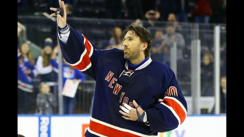 New York Rangers goalie Henrik Lundqvist waves to the crowd Saturday, February 11, after becoming the 12th goalie in NHL history to win 400 games.