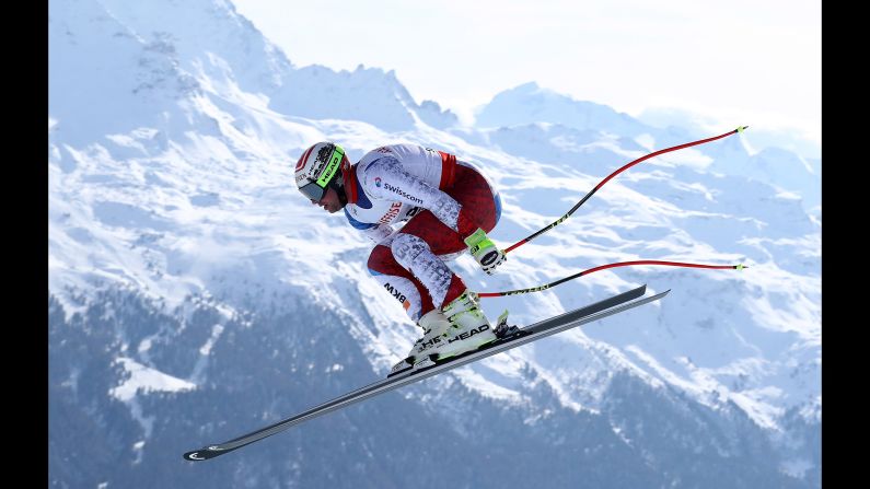 Swiss skier Beat Feuz soars through the air on his way to winning downhill gold at the World Championships in St. Moritz, Switzerland, on Sunday, February 12.