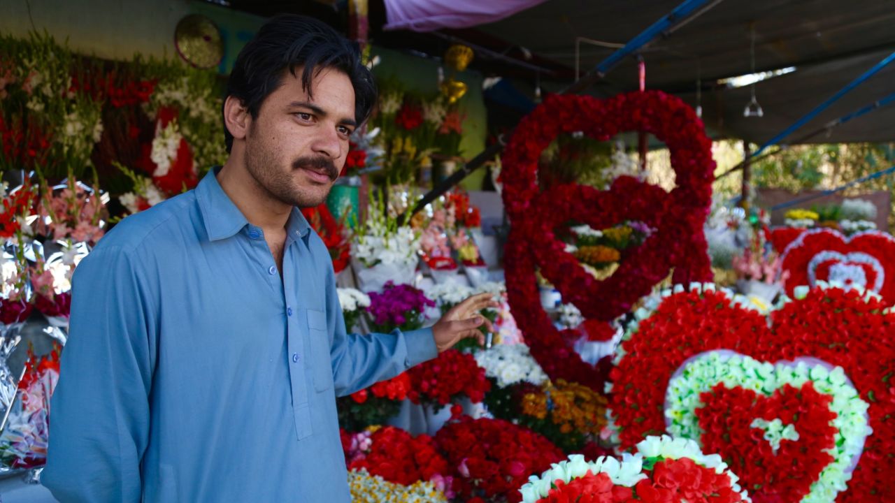 Sultan Zaib in front of his garlands of roses.
