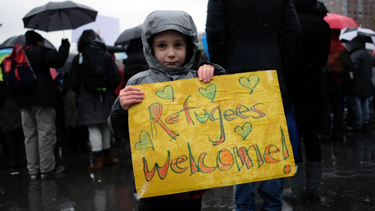 A boy holds a placard during a Jewish rally for refugees in New York on February 12, 2017.