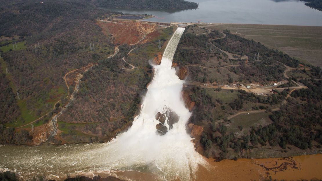 Oroville lake, the emergency spillway, and the damaged main spillway, are seen from the air on February 13, 2017 in Oroville, California. 