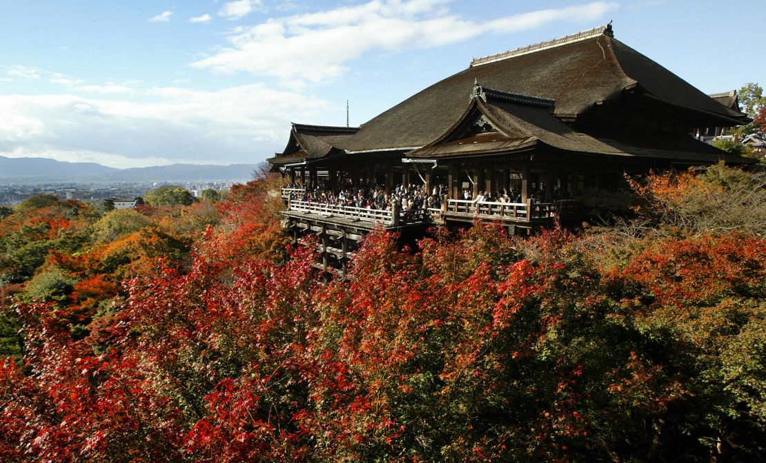 Autumnal leaves shroud Kiyomizu-dera Temple in Kyoto.