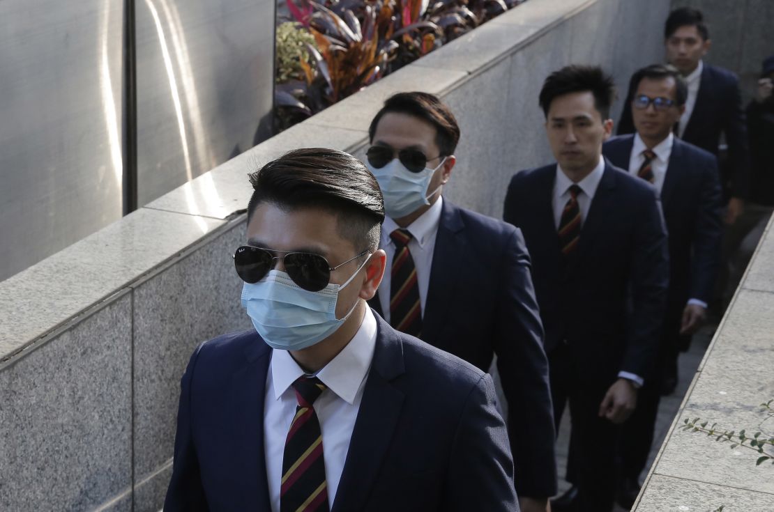 Five of the seven police officers charged with assaulting a pro-democracy activist on October 15, 2014, arriving at a district court in Hong Kong on February 14, 2017.
