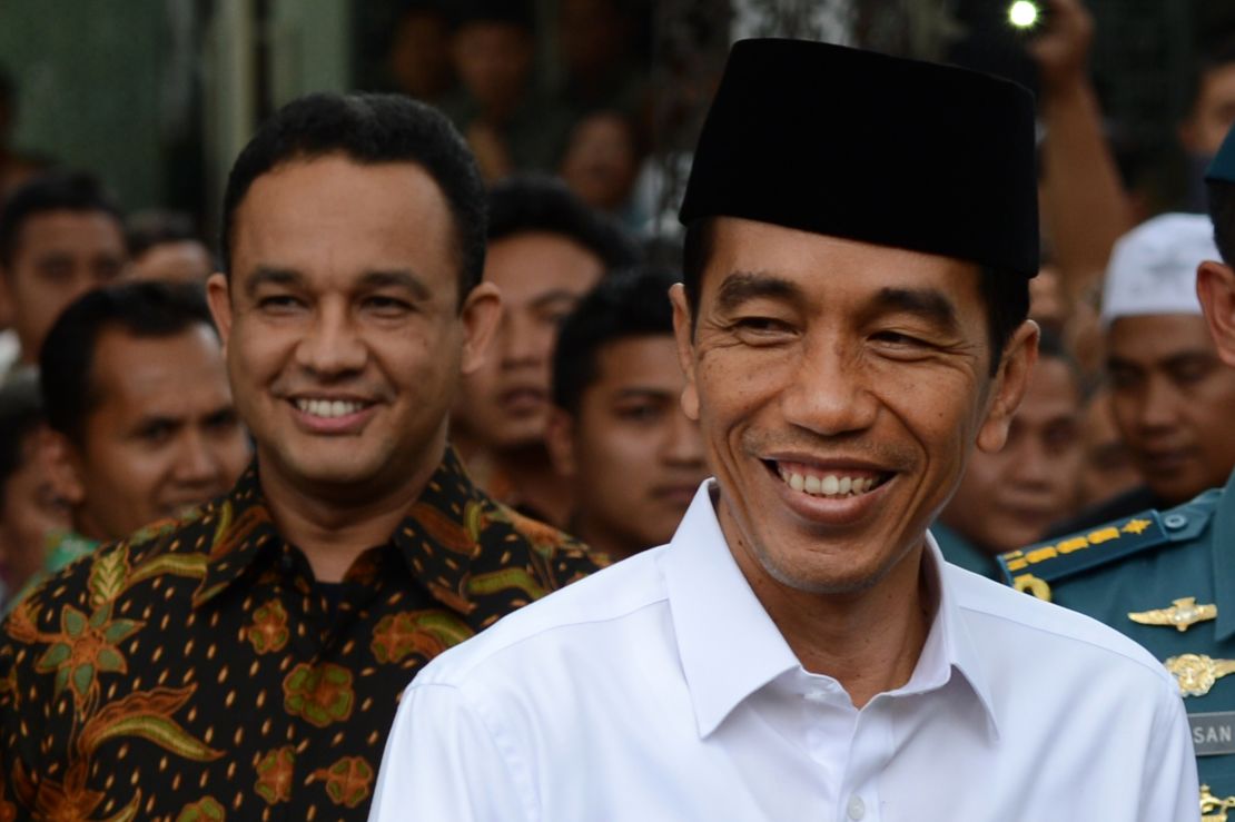 Indonesian President Joko Widodo (R) with Anies Baswedan (L) at the presidential palace in Jakarta on October 24, 2014.