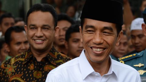 Indonesian President Joko Widodo (R) with Anies Baswedan (L) at the presidential palace in Jakarta on October 24, 2014.
