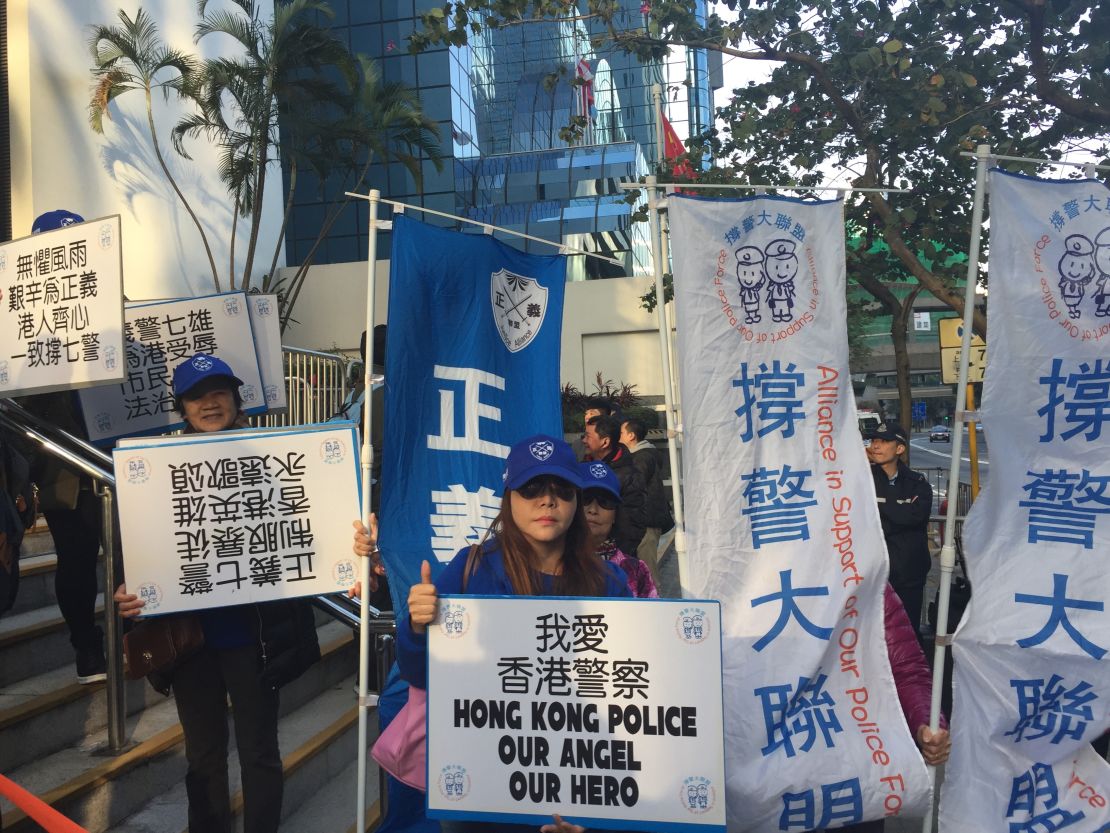 Police supporters chant slogans hold up banners in support of the seven convicted Hong Kong policemen.
